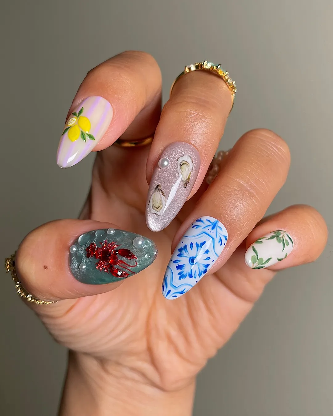 Mediterranean summer nail art with citrus, mosaic details, and a sparkling lobster