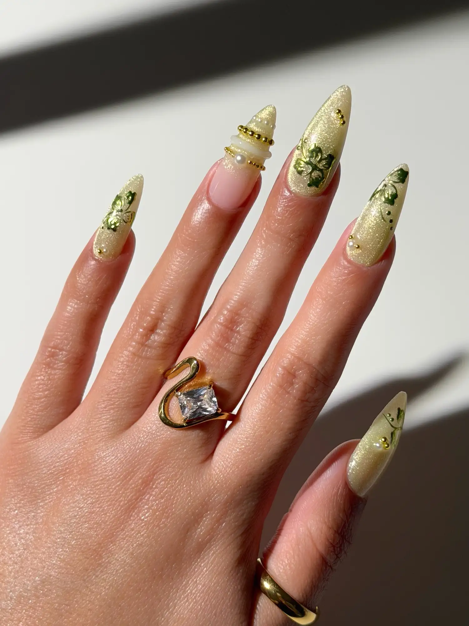 Butter-yellow manicure with metallic tropical blooms