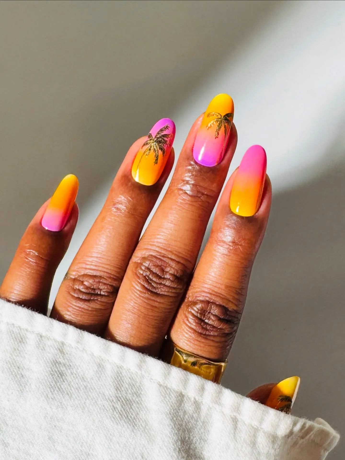 Sorbet sunset aura nails with palm-tree accents