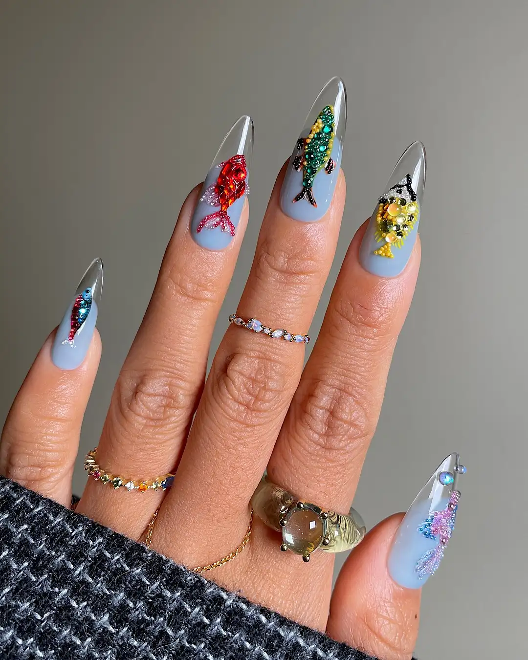 Translucent-tip nails with a light-blue base and colorful fish